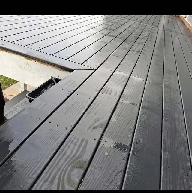 Contractor performing seasonal maintenance as part of comprehensive Deck Builder Services Sussex WI.